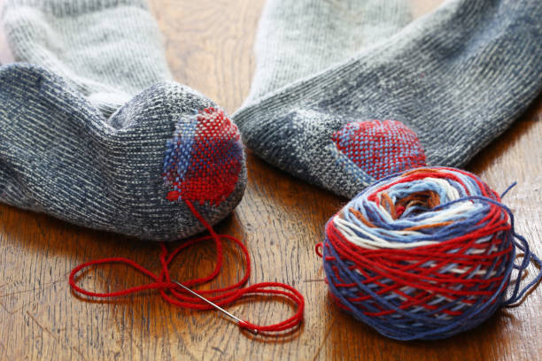 istock darning socks, repairing holes in socks 923405748