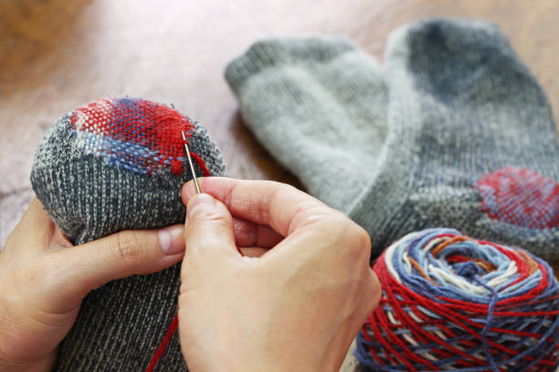 istock darning socks, repairing holes in socks 923405778