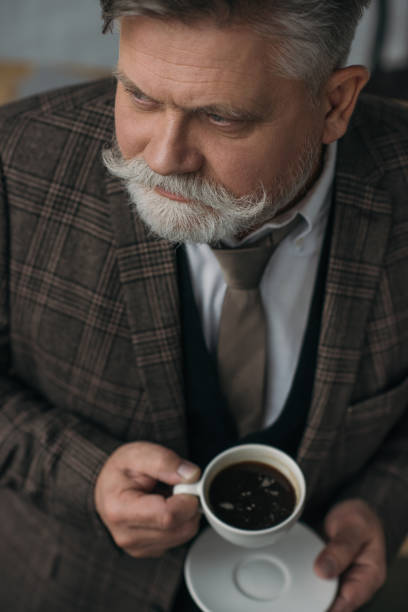 istock high angle view of senior man with cup of coffee 923406498
