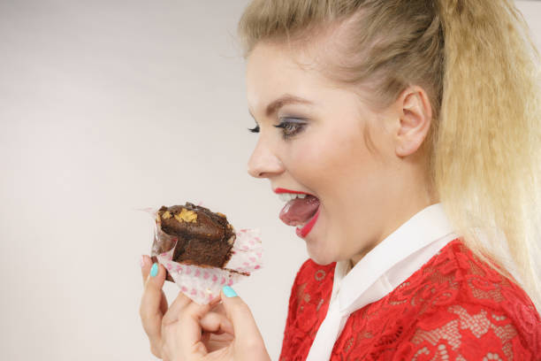 istock Attractive woman holds cake in hand 923410032