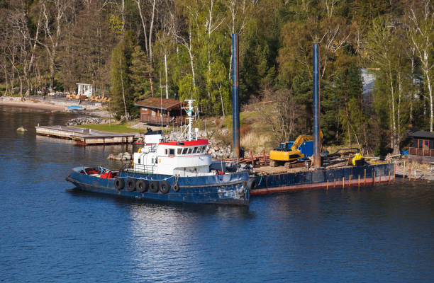 istock Industrial tugboat moored near floating pier 923412912