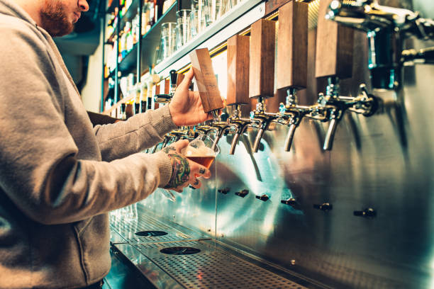 istock Hand of bartender pouring a large lager beer in tap 923416908
