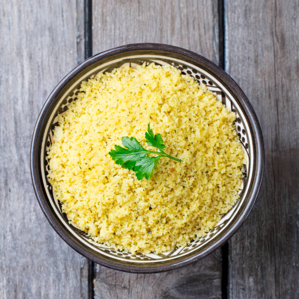 istock Couscous in bowl. Wooden background. Top view. 923418952