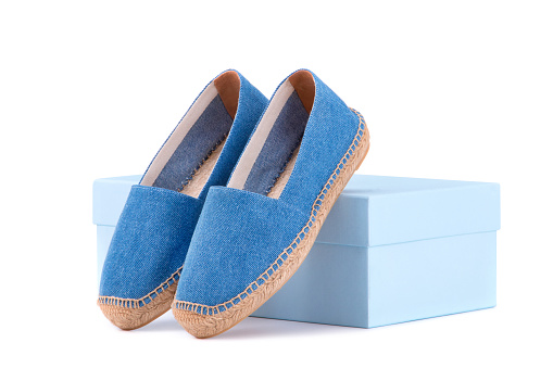 Espadrilles on the shoe box. Blue espadrilles on a white background