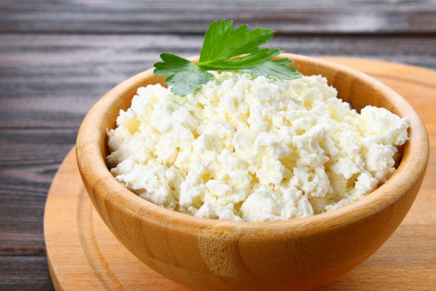 istock Home cottage cheese in a bowl on a wooden table. 923423164