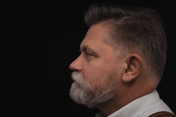 istock side view of senior man with stylish beard isolated on black 923427674