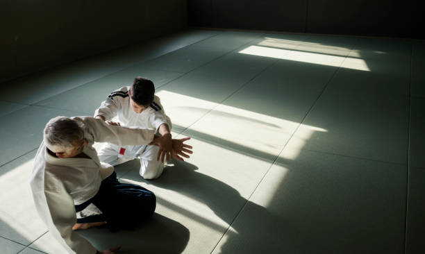istock Teen boy with his sansei practicing in dojo 923429904