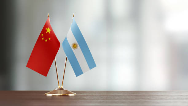istock Argentinian And Chinese Flag Pair On A Desk Over Defocused Background 923431094