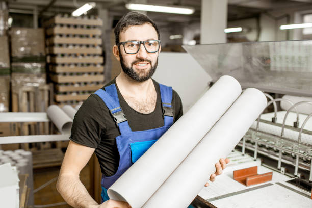 istock Worker portrait with paper tubes 923431200