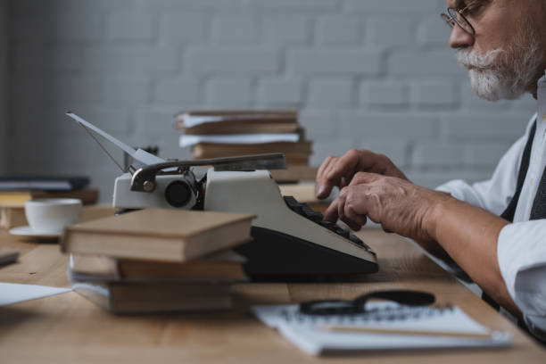 istock side view of serious senior writer working with typewriter 923431916