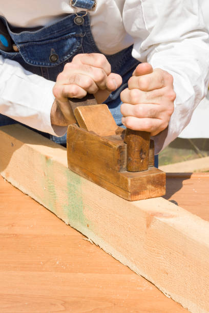 istock Hand plane. An employee plane the board. 923433740