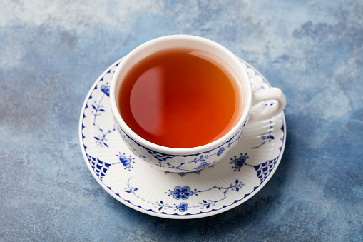 Cup of tea on a blue stone background.