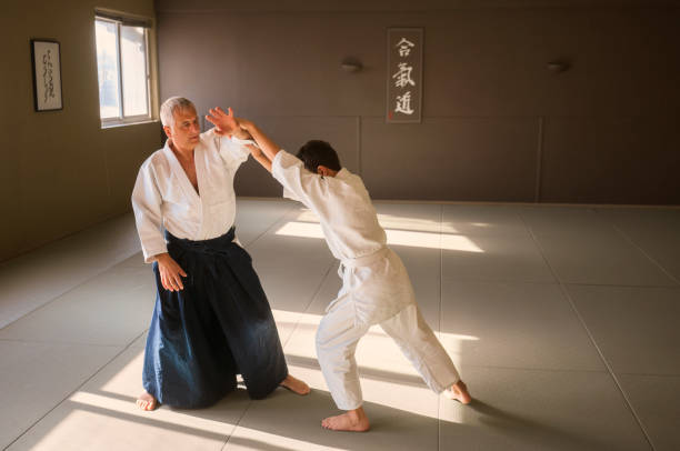 istock Teen boy with his sansei practicing in dojo 923435074