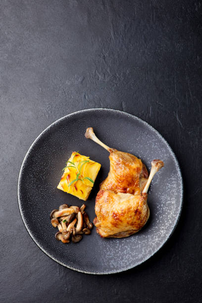 istock Duck legs confit with potato gratin and mushroom sauce . Restaurant serving. 923435146