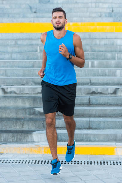 istock sportsman running on stairs 923435160