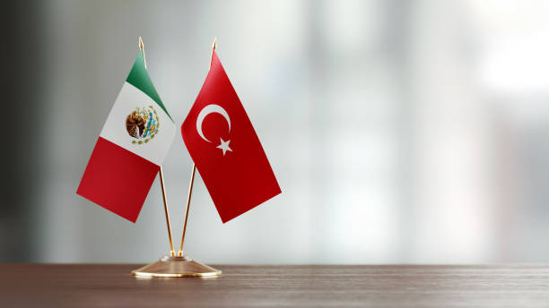 istock Mexican And Turkish Flag Pair On A Desk Over Defocused Background 923435236