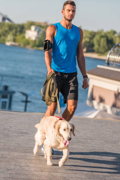 istock sportsman walking with dog 923435816