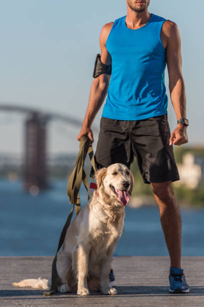 istock sportsman with dog on quay 923437880