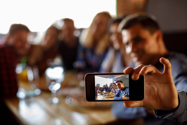 istock Group of friends taking selfie at a restaurant 923438418
