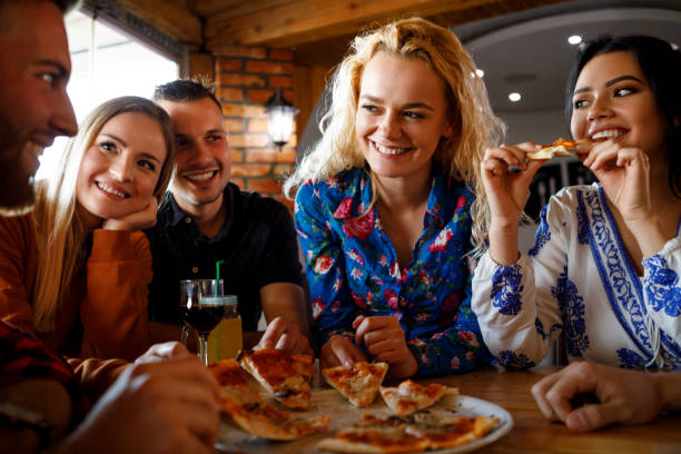 istock Friends enjoying pizza together 923438828