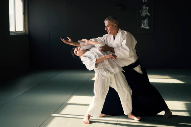istock Teen boy with his sansei practicing in dojo 923441820