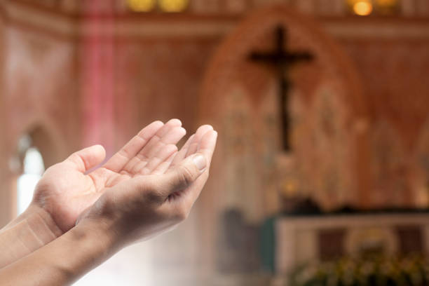 istock Human open empty hand with palms up(Praying Hand) on blurred church interior background 923443862