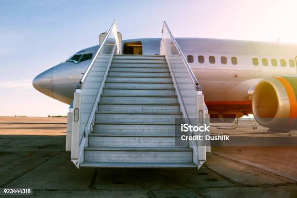 Passenger Airplane With A Boarding Steps In The Morning Sun Stock Photo - Download Image Now