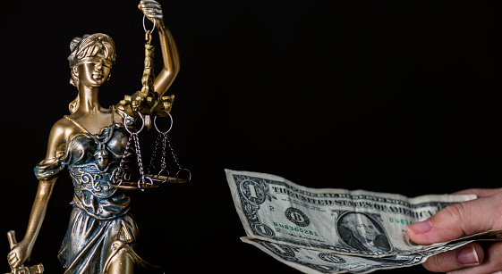 Lady justice with dollars.