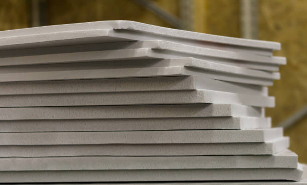 polystyrene slabs lie a tower close-up of gray color polystyrene slabs lie a tower close-up of gray color. heat insulation for home brick house isolated stock pictures, royalty-free photos & images