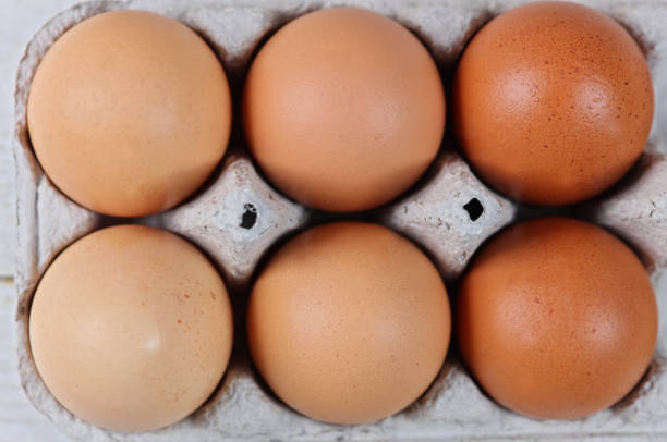 istock Farm Fresh Chicken Eggs arranged by color. Easter concept 923459452