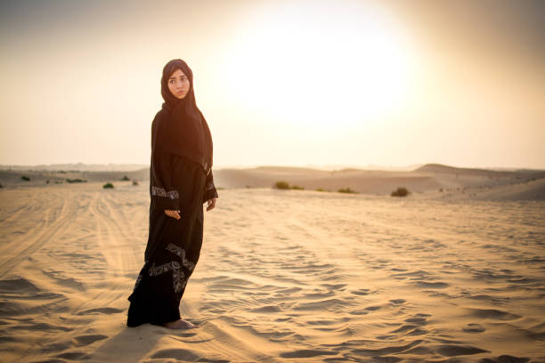 istock Arab woman standing in the desert during sunset. 923459732