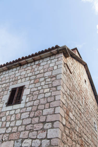 istock old stone wall of a building with a window. 923465904