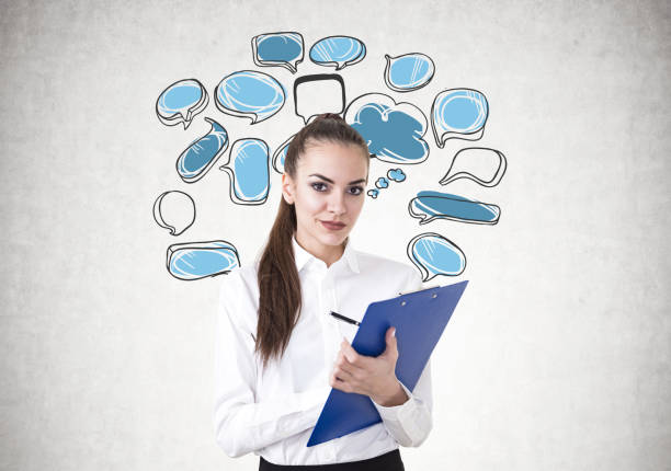 istock Young businesswoman writing, speech bubbles 923470098