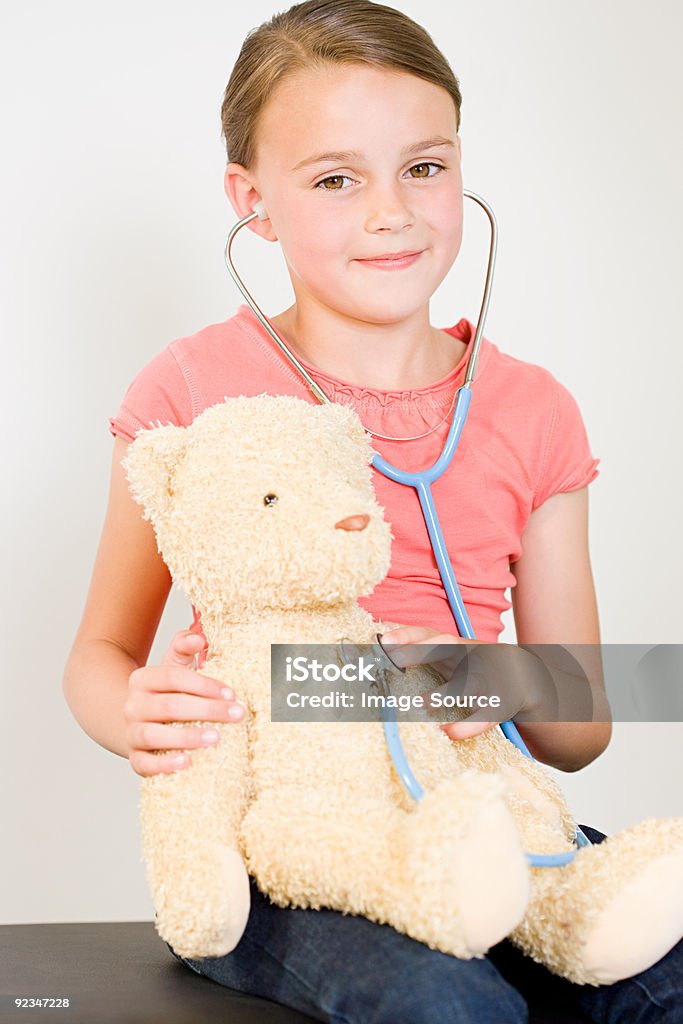 Girl with teddy bear and stethoscope  6-7 Years Stock Photo