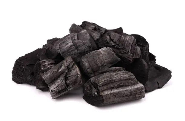 Pile of charcoal isolated on white