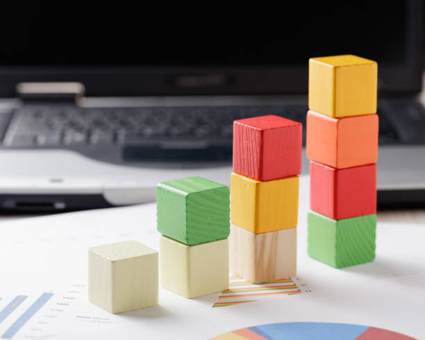 istock building blocks cubes against blur laptop background 923482098