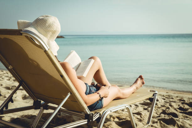 istock Reading on Sunbed at the Seaside 923486016