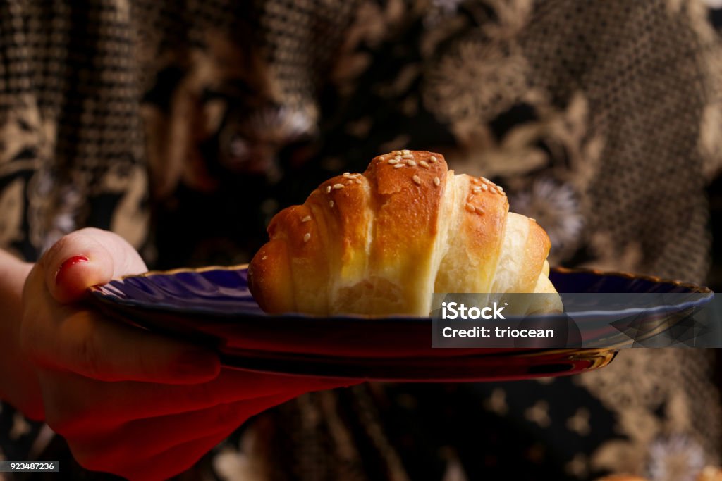 Woman eating croissant Adult Stock Photo