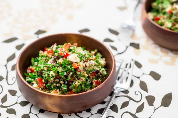 Greek style tabbouleh salad. This healthy dish mixes tabbouleh & greek style salads, using fresh parsley herb, olives, onions, feta and replacing the bulgur usually found in tabouleh with quinoa.