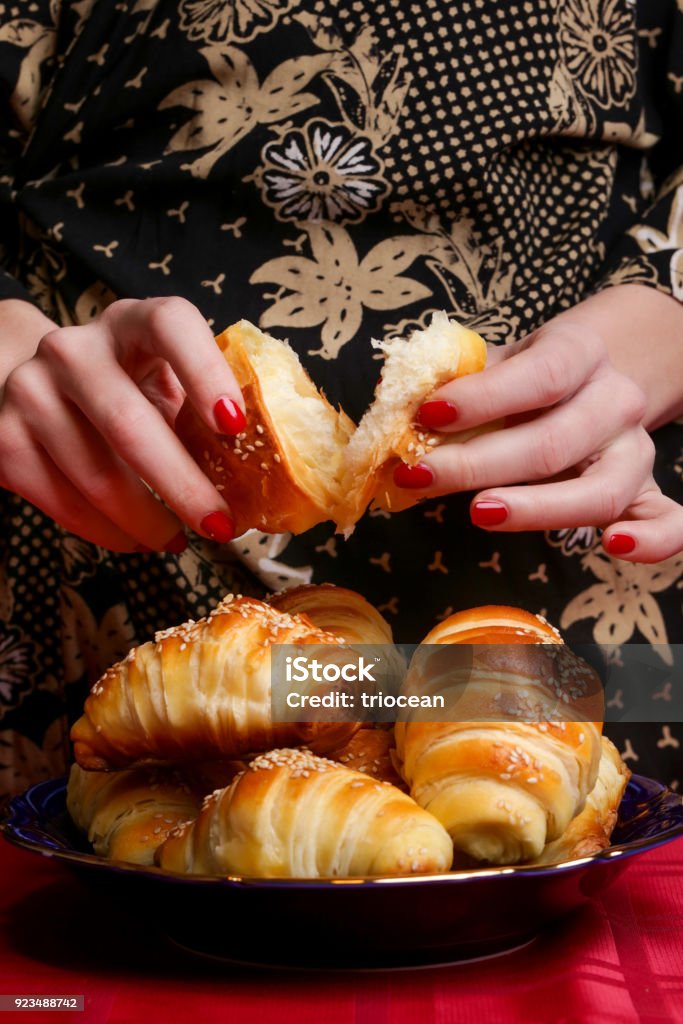 Woman eating croissant Adult Stock Photo