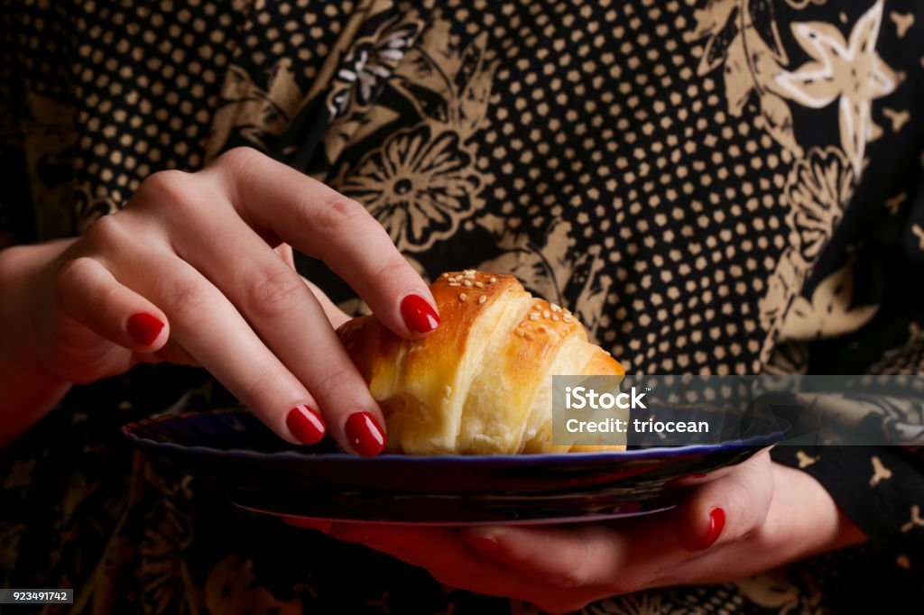 Woman eating croissant Adult Stock Photo