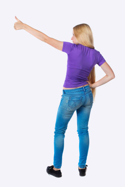 istock Back view of  pointing woman. 923494532