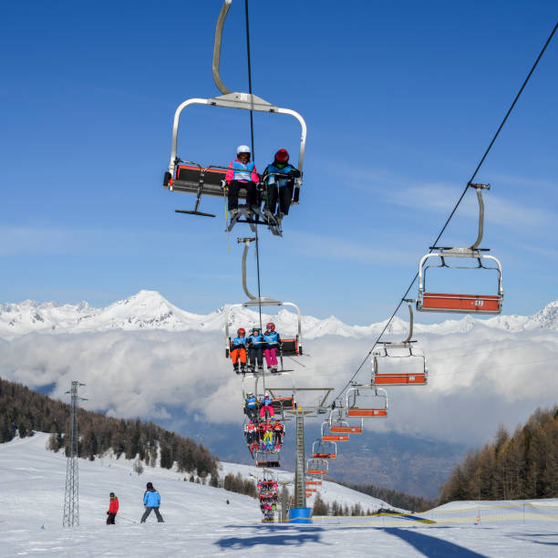 Aerial view of northern Italian city of Aosta and surrounding Valle d'Aosta from Pila ski resort - chairlifts and ski runs Pila, Aosta, Italy - Feb 19, 2018: Aerial view of northern Italian city of Aosta and surrounding Valle d'Aosta from Pila ski resort - chairlifts and ski runs pila stock pictures, royalty-free photos & images