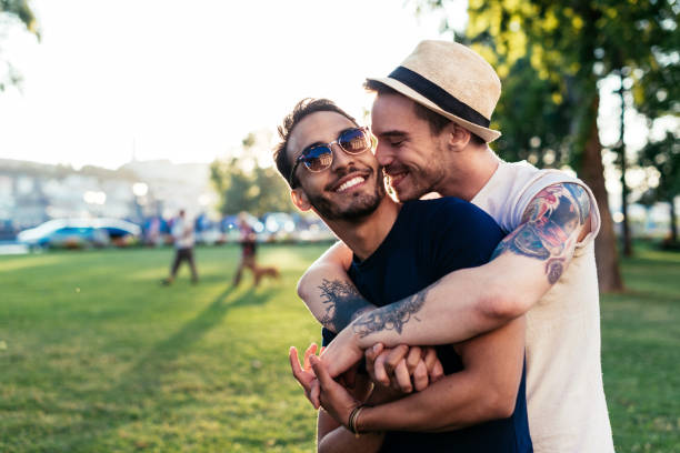 istock Gay couple in park hugging 923494752