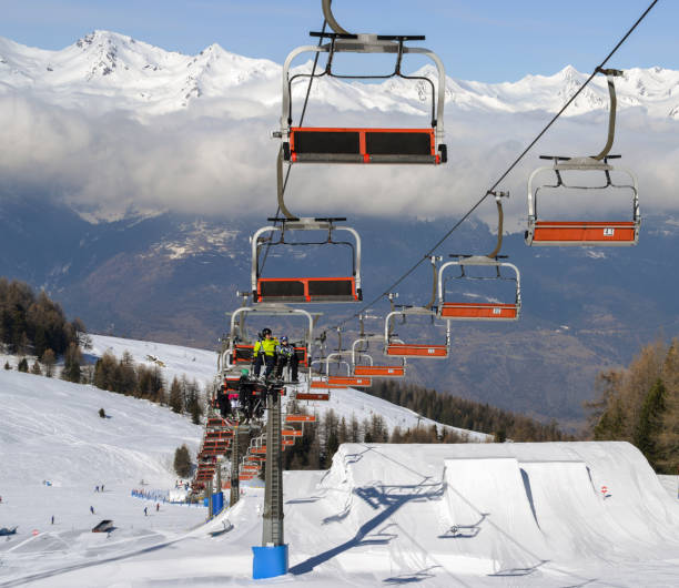 Aerial view of northern Italian city of Aosta and surrounding Valle d'Aosta from Pila ski resort - chairlifts and ski runs Pila, Aosta, Italy - Feb 19, 2018: Aerial view of northern Italian city of Aosta and surrounding Valle d'Aosta from Pila ski resort - chairlifts and ski runs pila stock pictures, royalty-free photos & images