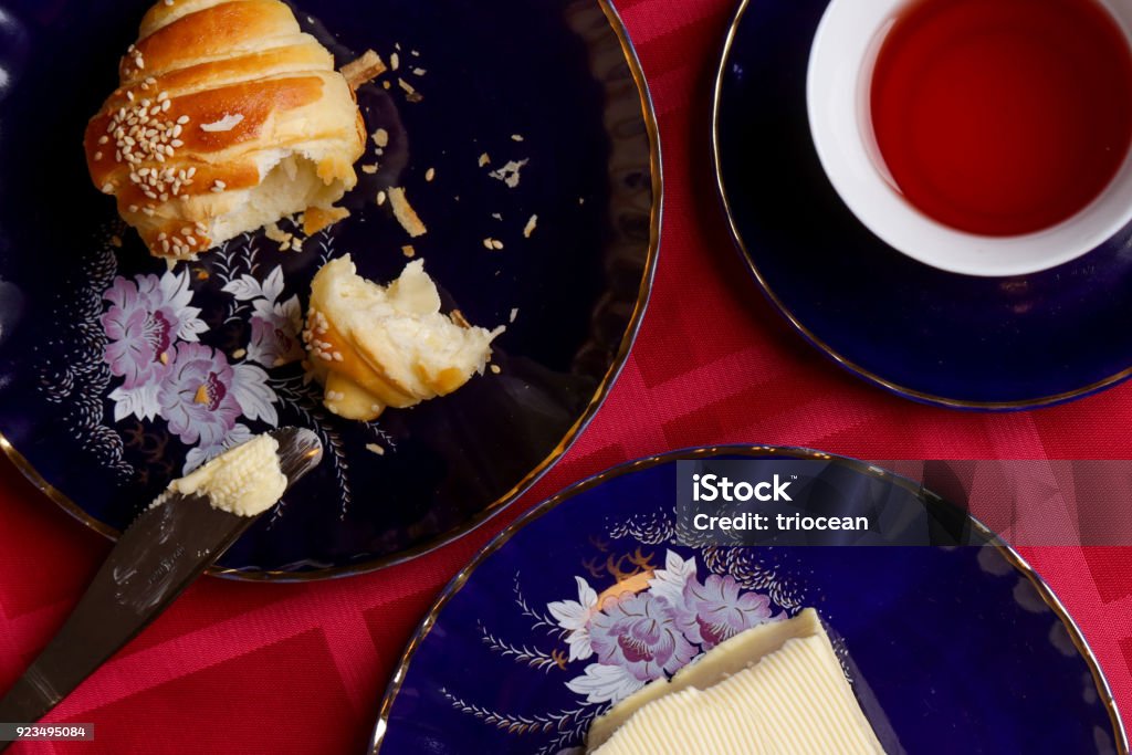 Simple delicious meal - freshly baked croissants, butter and cup of tea Baked Stock Photo