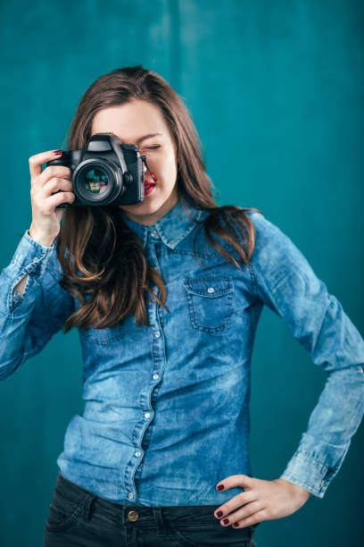 istock Beautiful young girl with photo camera 923496440
