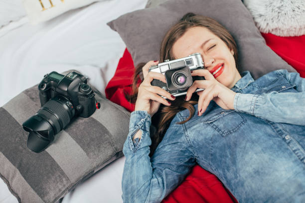 istock Beautiful young girl with photo camera 923497290