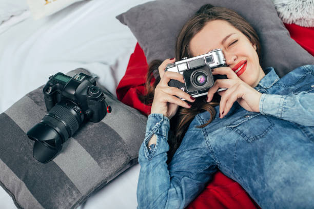 istock Beautiful young girl with photo camera 923497306