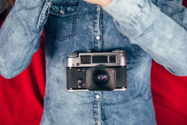 istock Beautiful young girl with photo camera 923497312